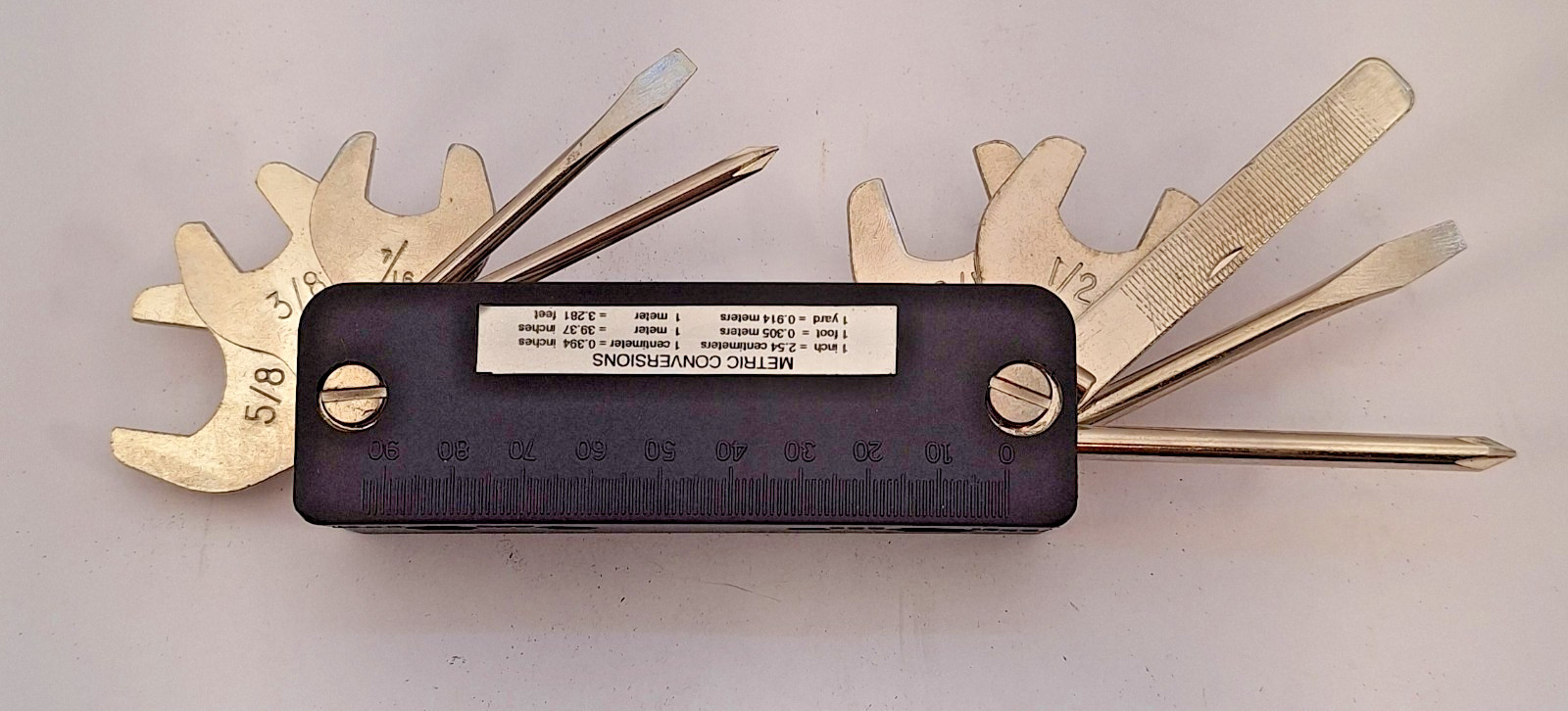 Unbranded Multitool with pouch, wrenches, screwdivers, metric chart and more.